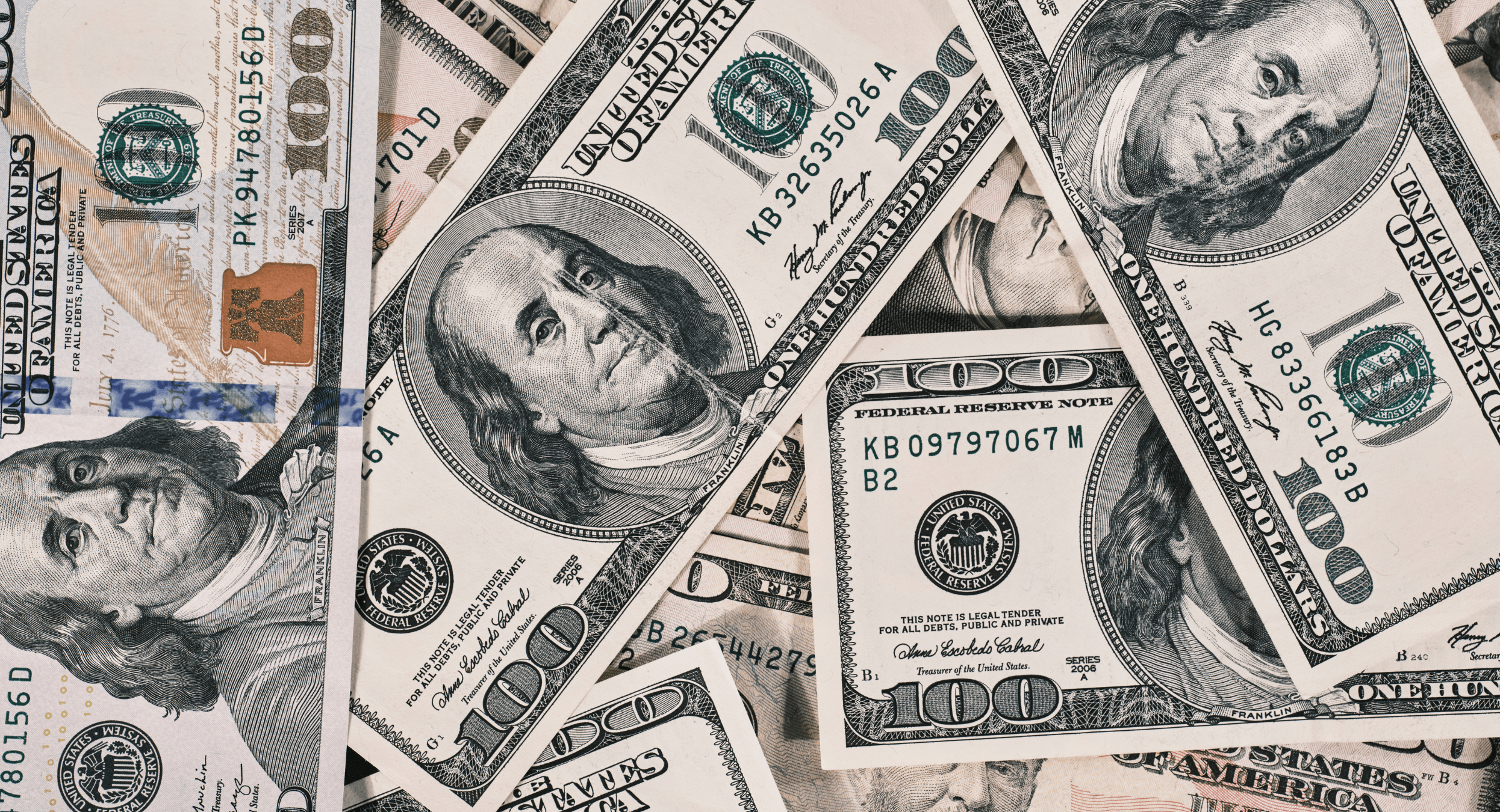 US dollar weakness - Decorative image of dollar bills spread out