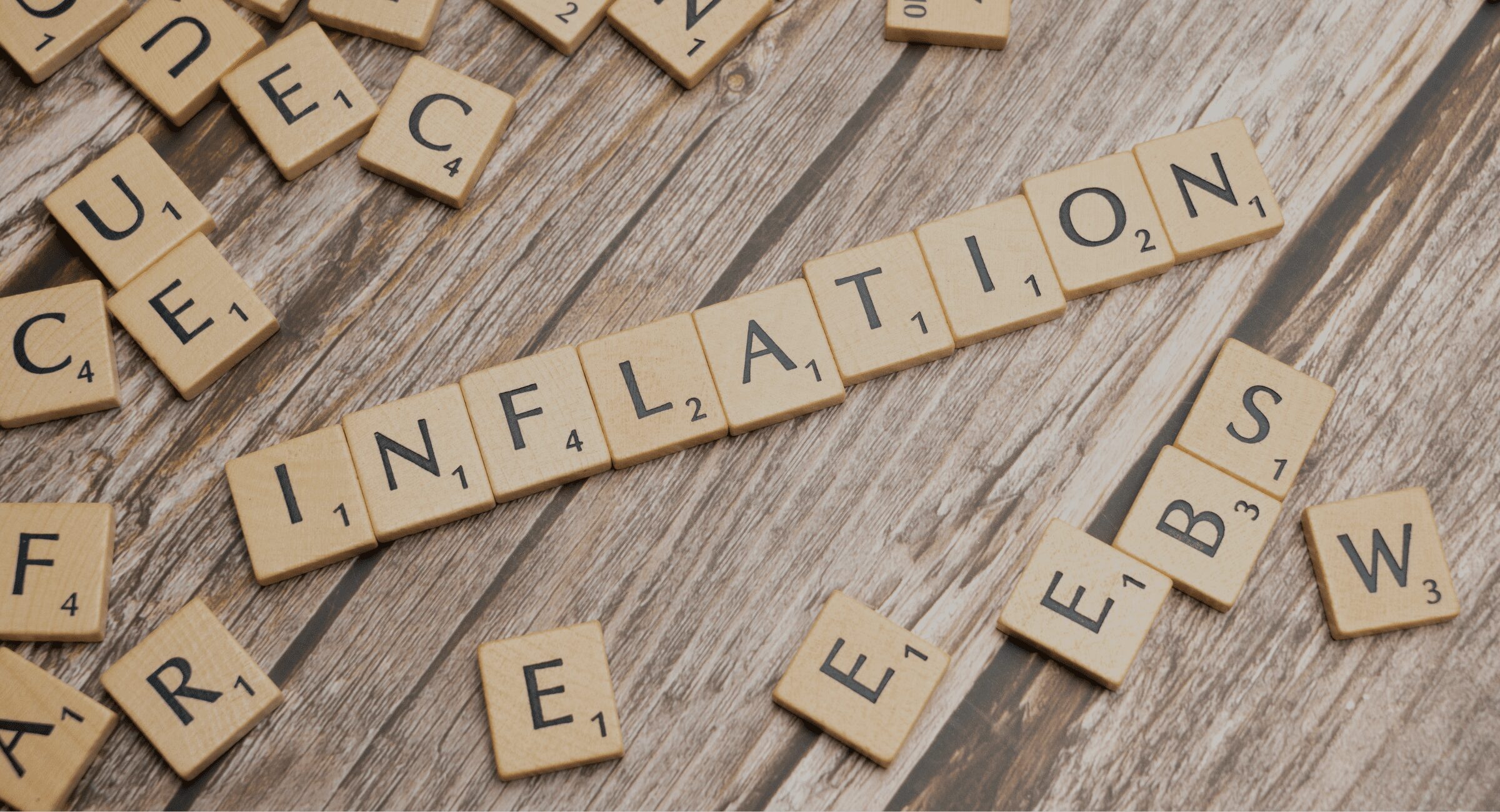 a photo of scrabble letters spelling out inflation