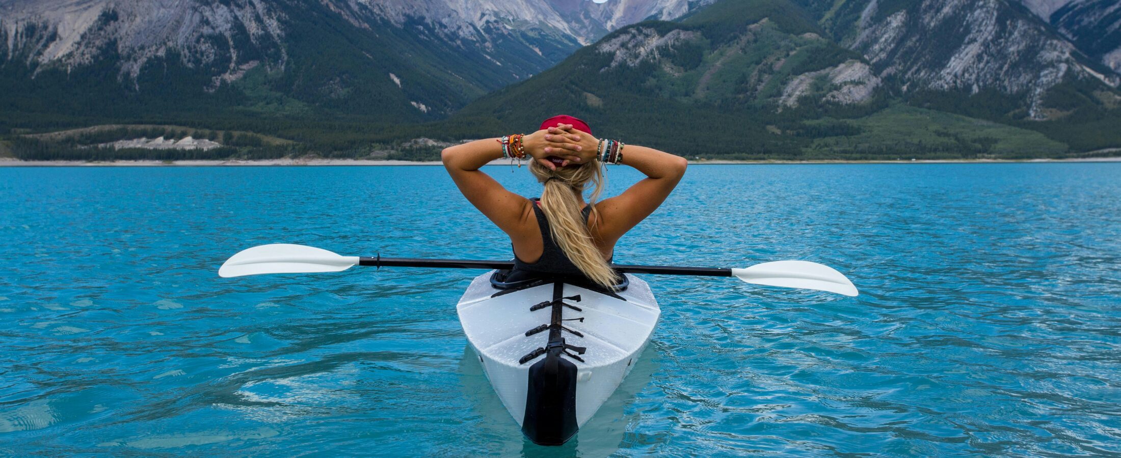 A woman on a kayak relaxing after speaking with Henson Crisp Independent Financial Advisers in Peterborough and Cambridge