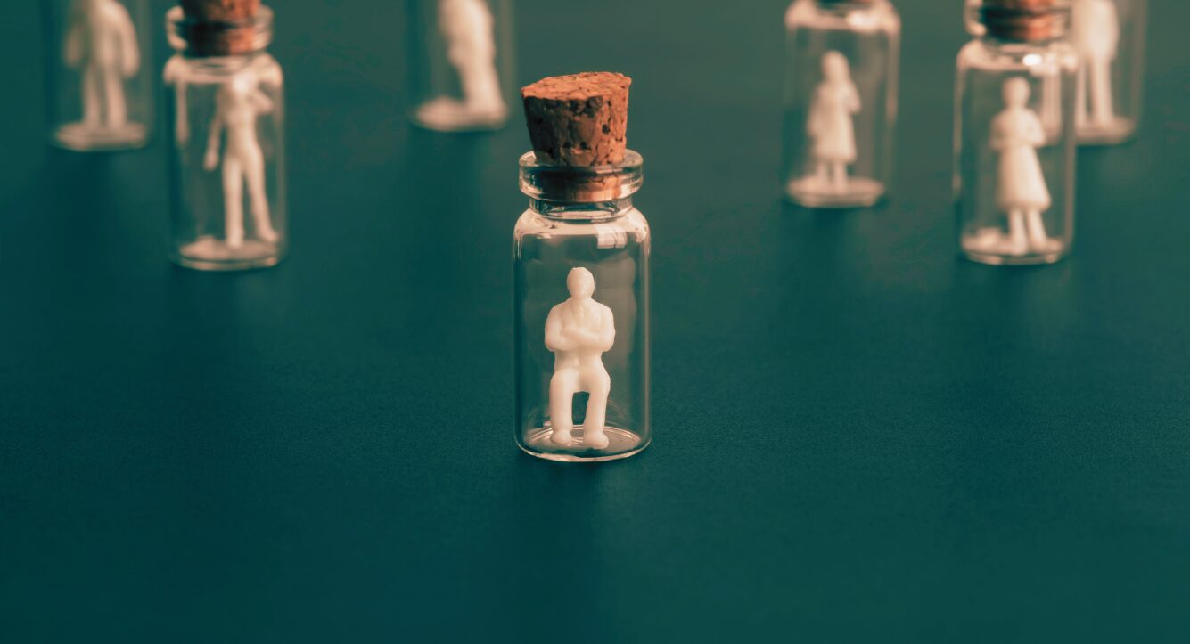 Small human figures in jars n their own to symbolise vulnerable clients and how we adapt our communications fo vulnerable clients