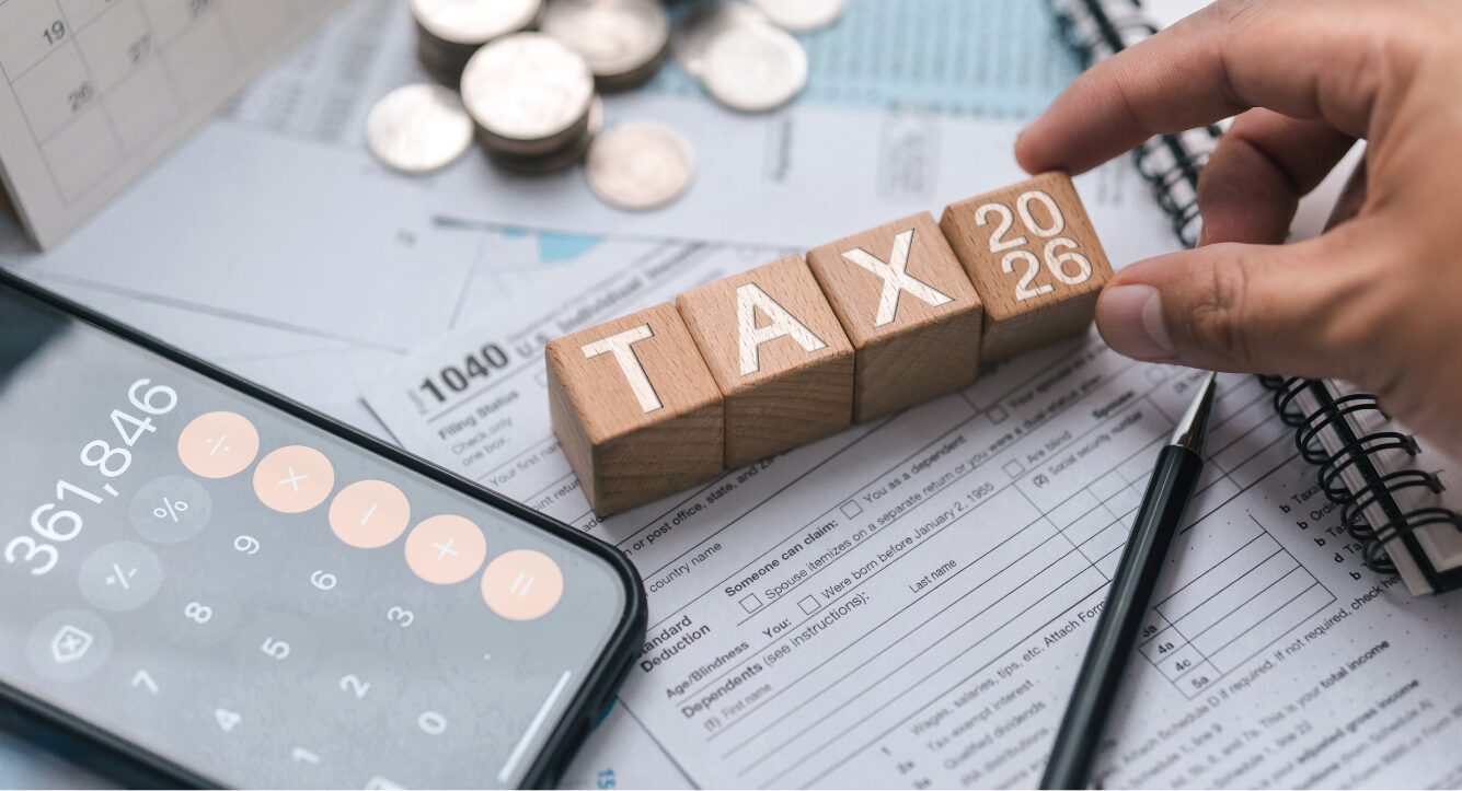 decorative image of blocks spelling out taxes with a flat lay of UK tax receipts