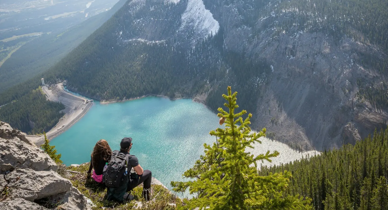 An image of a couple sitting admiring the view of a mountain - decoratively used to depict our client stories of financial success